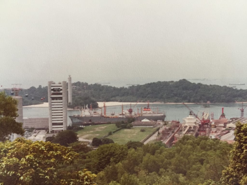 View of St John's Island from the sea, with Sentosa in the distance