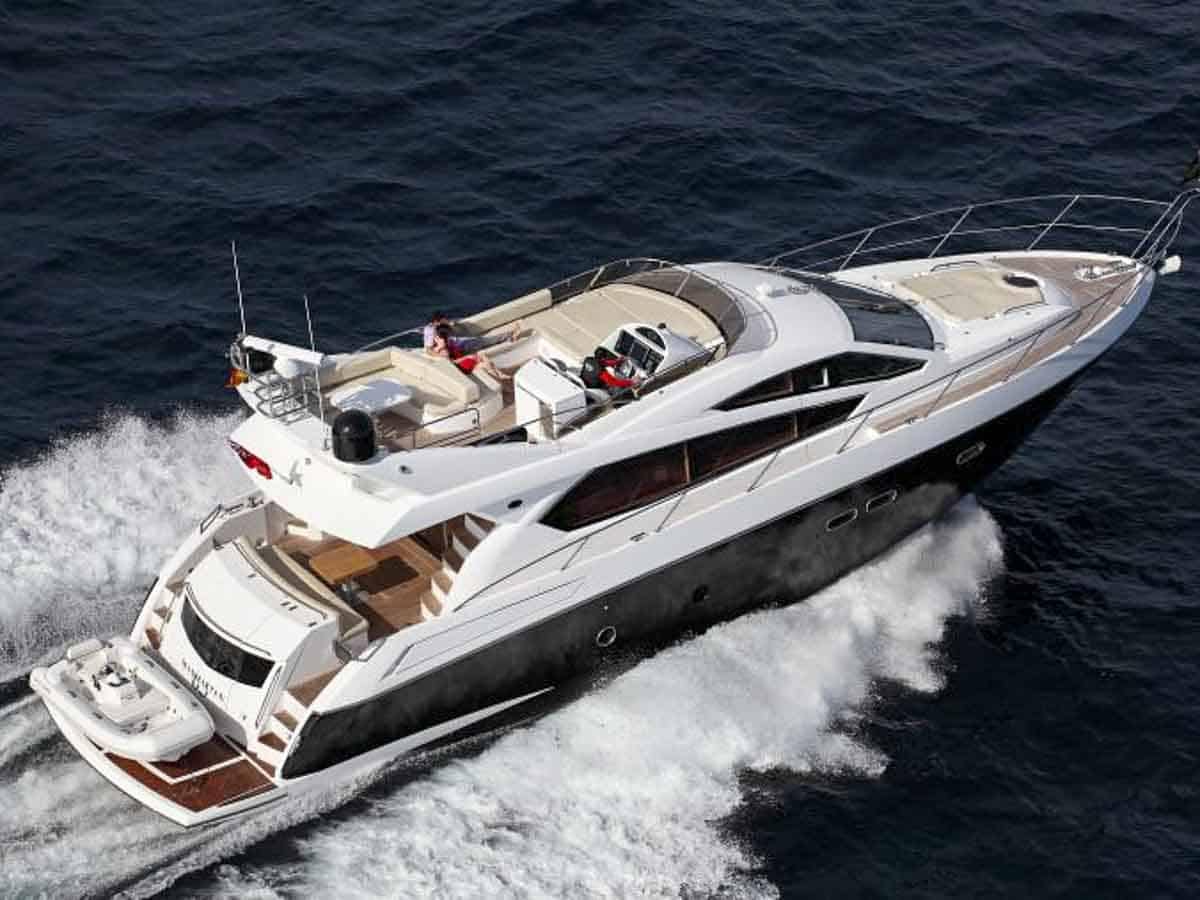 Sunseeker 63 sport yacht aerial view at speed on dark blue water with cream deck seating Singapore charter