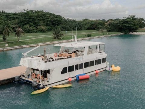 MS Eternity 1 bow view at Singapore marina dock with yellow banana boat water toy in the water